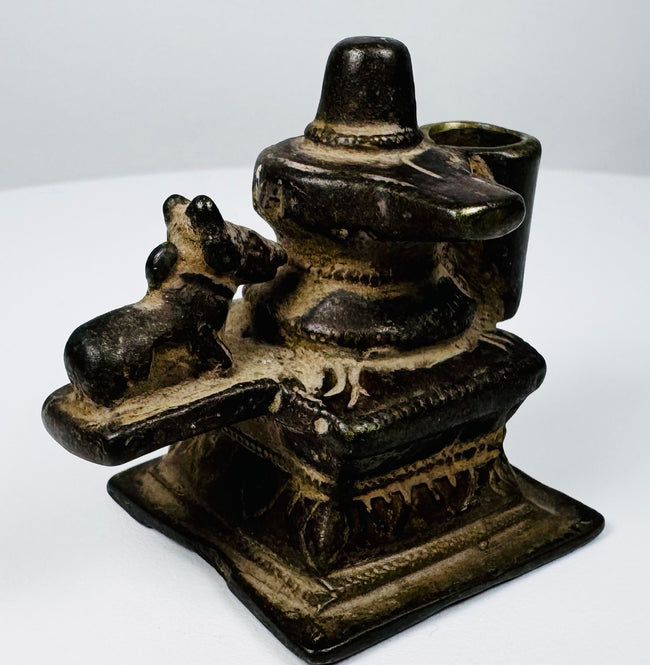 Small 19th century Indian brass Hindu shrine depicting Shiva Lingam and Nandi with historic patina.