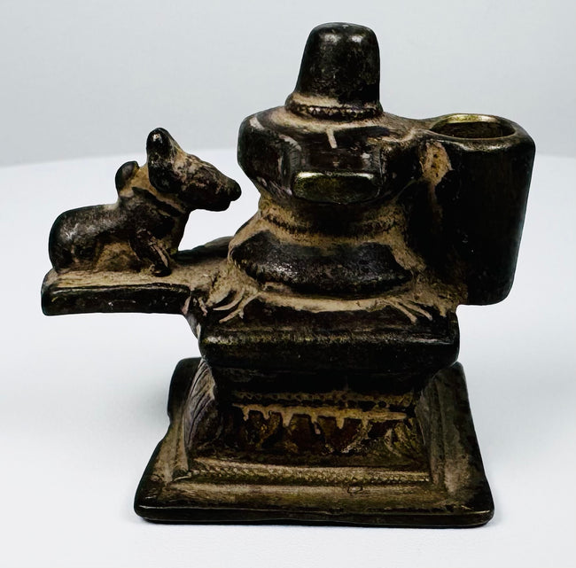 19th century cast brass Shiva shrine from India featuring Lingam, Nandi, and decorative stepped base.