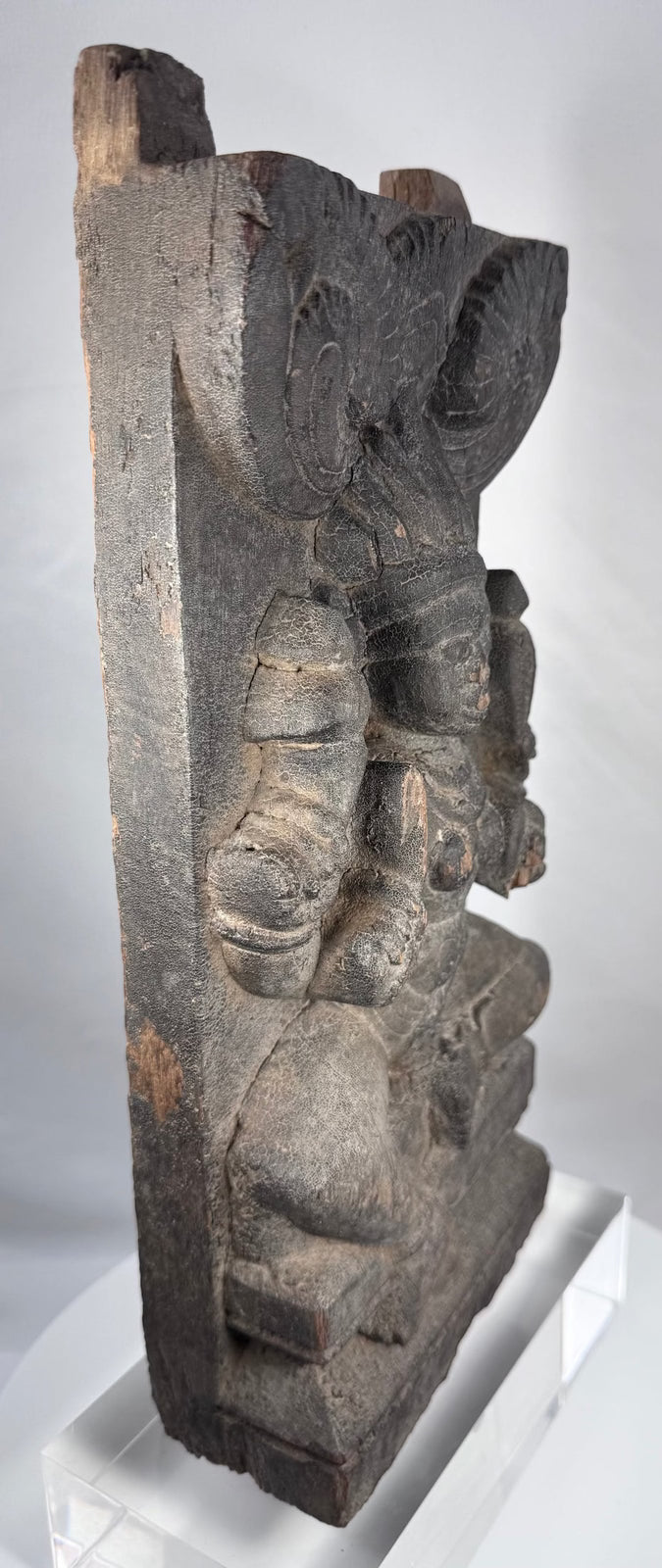 Indian religious carving with aged timber surface and projecting wooden tenons