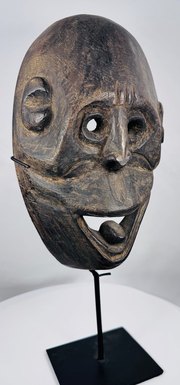 Historic Indonesian ceremonial mask from Fatuleu Village exhibiting distinctive carved facial features and natural aged wear.