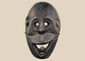 Carved wooden ritual mask from Fatuleu Village, West Timor, featuring large circular eyes and a protruding tongue, circa 1930.