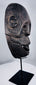 Circa 1930 tribal mask from West Timor carved from a single piece of hardwood and mounted for display.