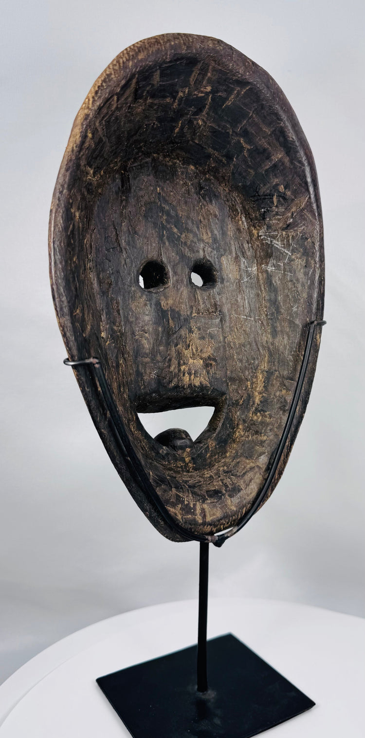 Antique carved wood mask from Fatuleu Village with projecting muzzle, circular eyes, and traditional tribal design.