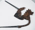 Decorative Indonesian betel nut cutter with dark iron patina, scrolling motifs and sculpted animal head