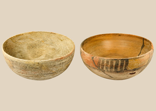 Two ancient Indus Valley terracotta bowls, circa 2nd–3rd millennium BCE; one plain with natural earthen patina, the other decorated with geometric polychrome painted motifs, both exhibiting age wear and archaeological restoration.