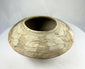 Side view of Indus Valley pottery bowl with symbolic fish motifs and natural clay surface.
