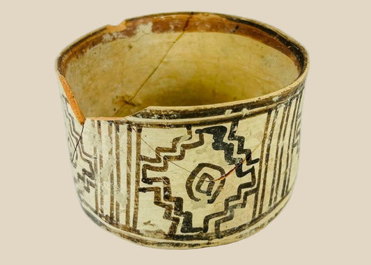 Indus Valley painted pottery vessel, 3rd millennium BCE, cylindrical form with black geometric motifs on cream surface and aged patina.