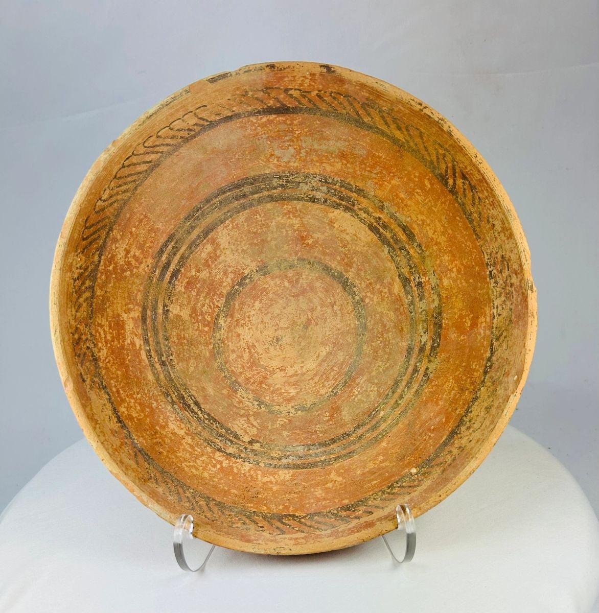 Indus Valley terracotta dish, 2nd millennium BCE, with painted concentric circles and geometric motifs in natural pigments, shallow ceremonial form.
