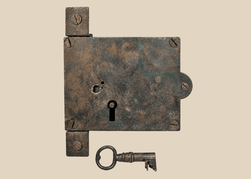 Antique 19th century iron rim lock with original skeleton key on display
