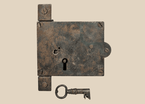 Antique 19th century iron rim lock with original skeleton key on display
