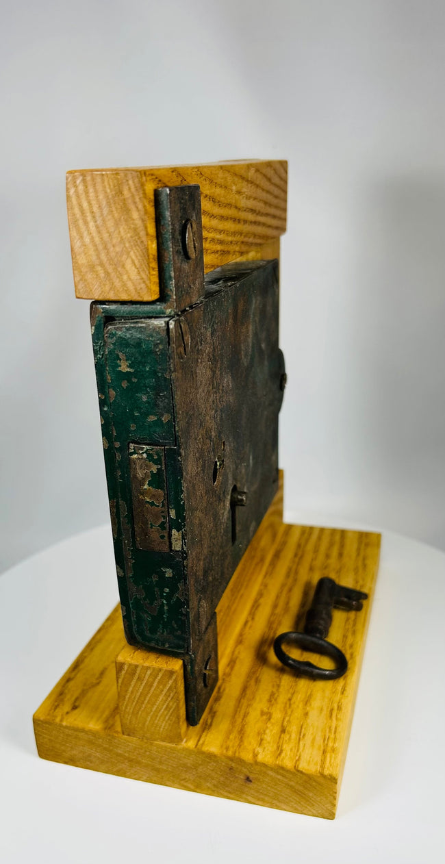 19th century architectural lock with iron key and aged painted backing