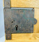 Vintage door rim lock mechanism with original iron key and hardware