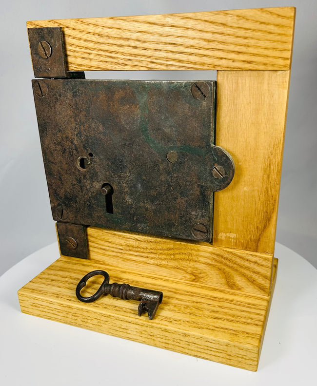 Antique iron lock with visible screws and worn painted reverse surface