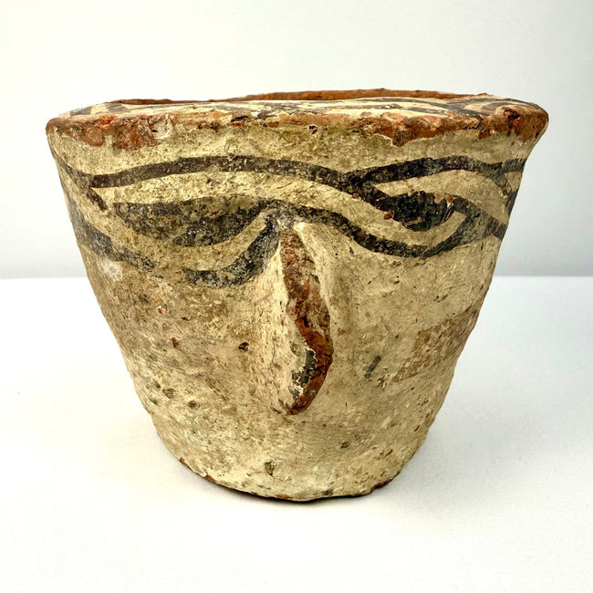 Three-quarter view of 12th century CE decorated pottery vessel