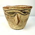 Three-quarter view of 12th century CE decorated pottery vessel