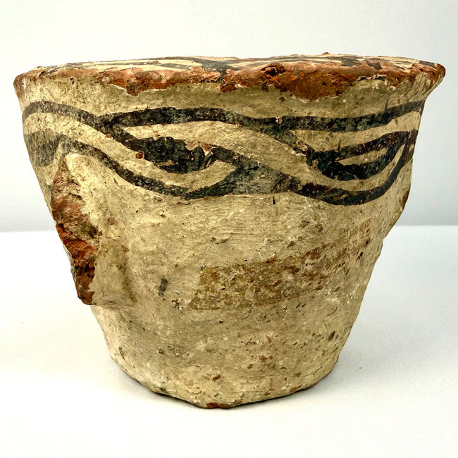 Medieval Afghan earthenware mortar with black painted slip designs encircling the upper rim and distinctive side protrusions.