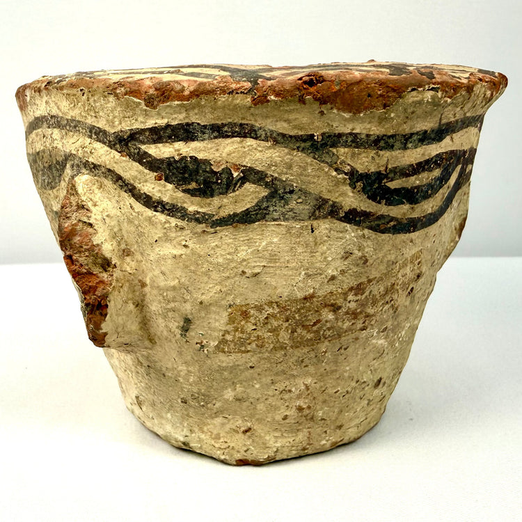 Medieval Afghan earthenware mortar with black painted slip designs encircling the upper rim and distinctive side protrusions.