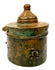 Khorassan bronze inkwell featuring surviving applied metal fittings, decorative engravings, and an irregular archaeological surface texture.