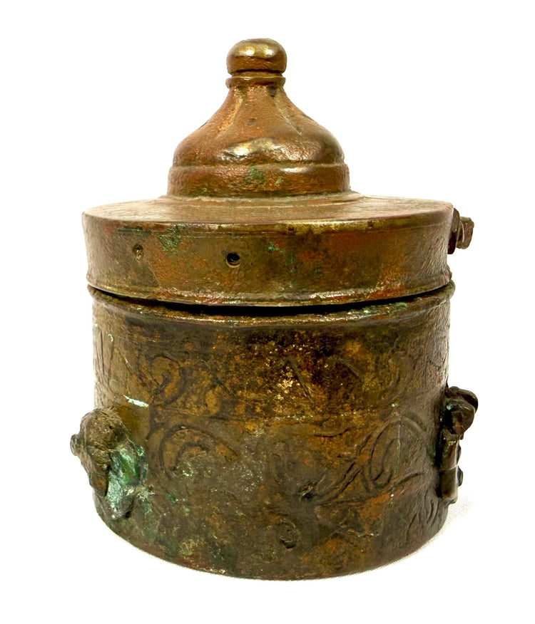 Historical Khorassan bronze writing accessory featuring a fitted domed lid, pronounced circular mouldings, and traditional Islamic metalworking details.