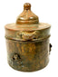 Islamic Golden Age bronze inkwell displaying intricate engraved scrolling, geometric, and circular motifs across its cylindrical body.