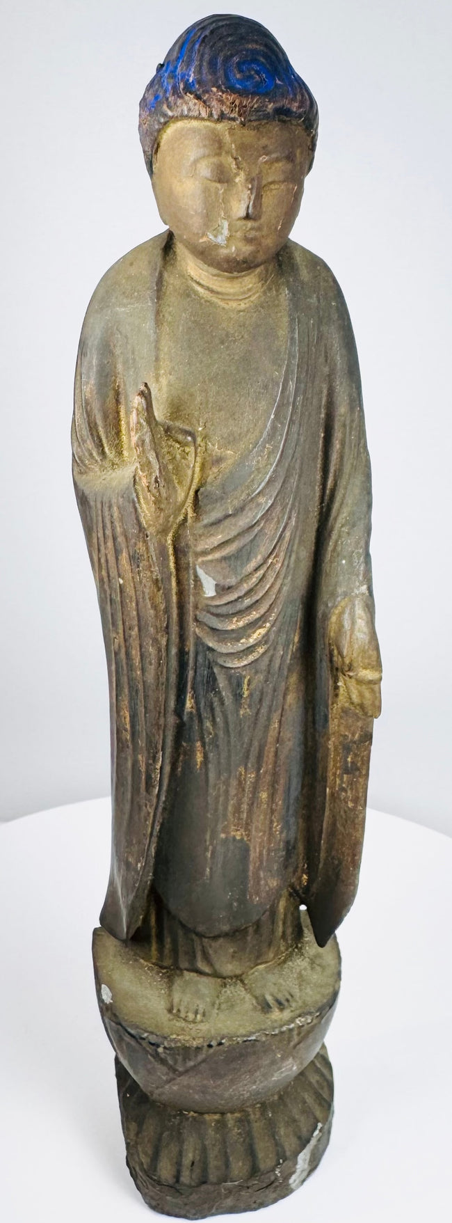Front view of a Japanese Amida Buddha statue with gilding and blue-painted hair