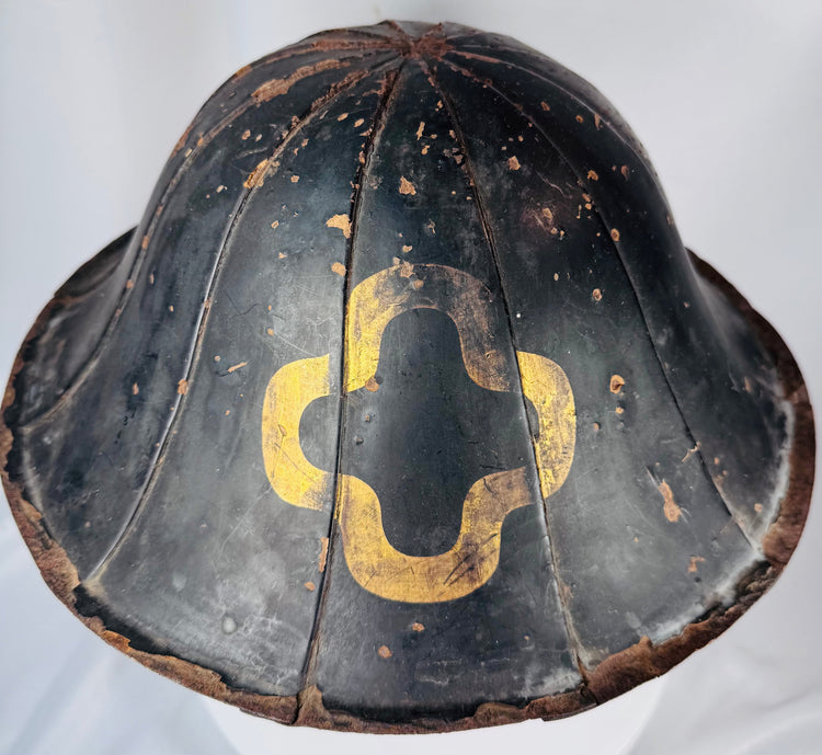Traditional Edo era Japanese martial headwear with ribbed lacquered exterior and mon crest