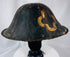 Historic Japanese samurai helmet with weathered lacquer finish and visible age-related wear