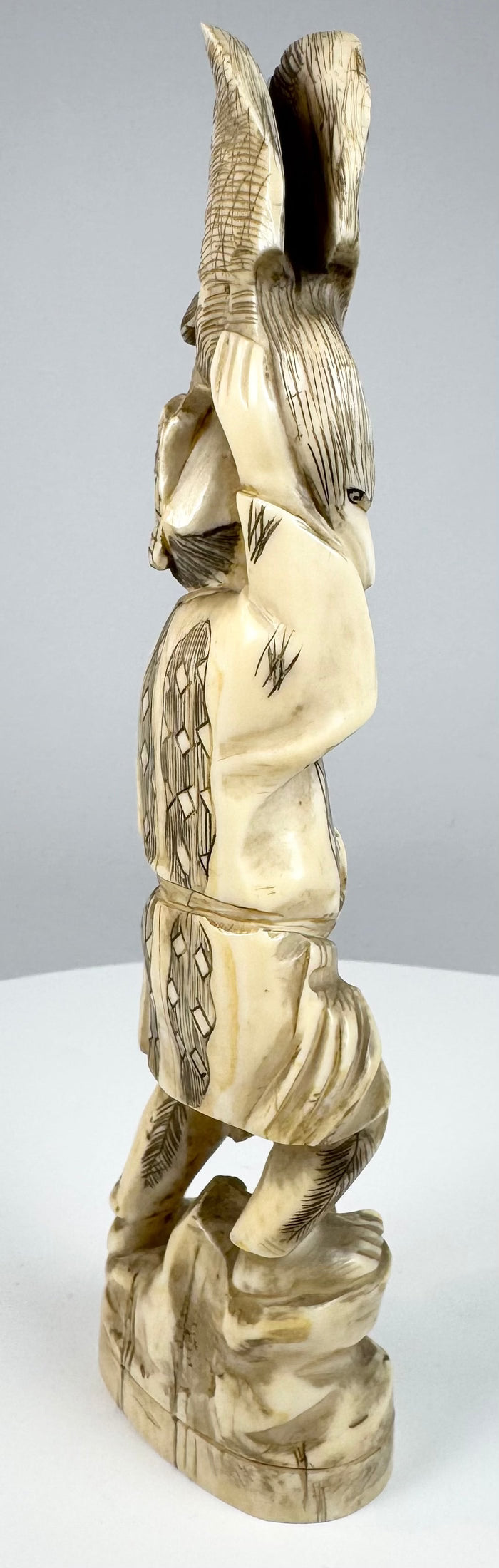 Rear view showing incised garments and sectional construction of the Japanese okimono