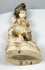 Underside of the Japanese falconer okimono showing the rocky base and red mark