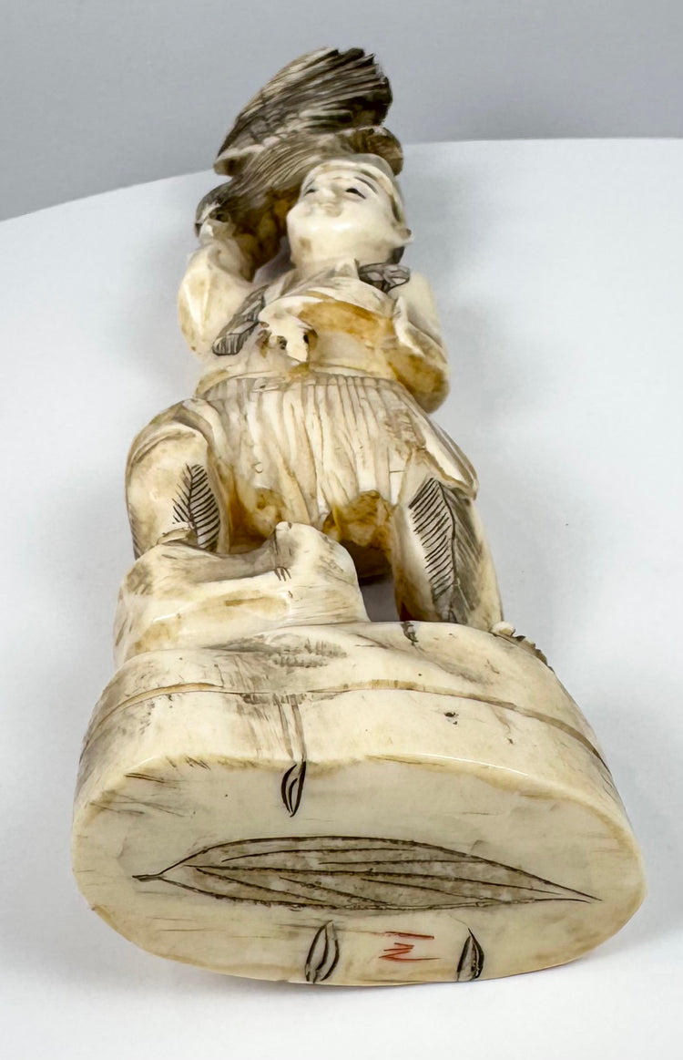 Underside of the Japanese falconer okimono showing the rocky base and red mark