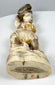 Underside of the Japanese falconer okimono showing the rocky base and red mark