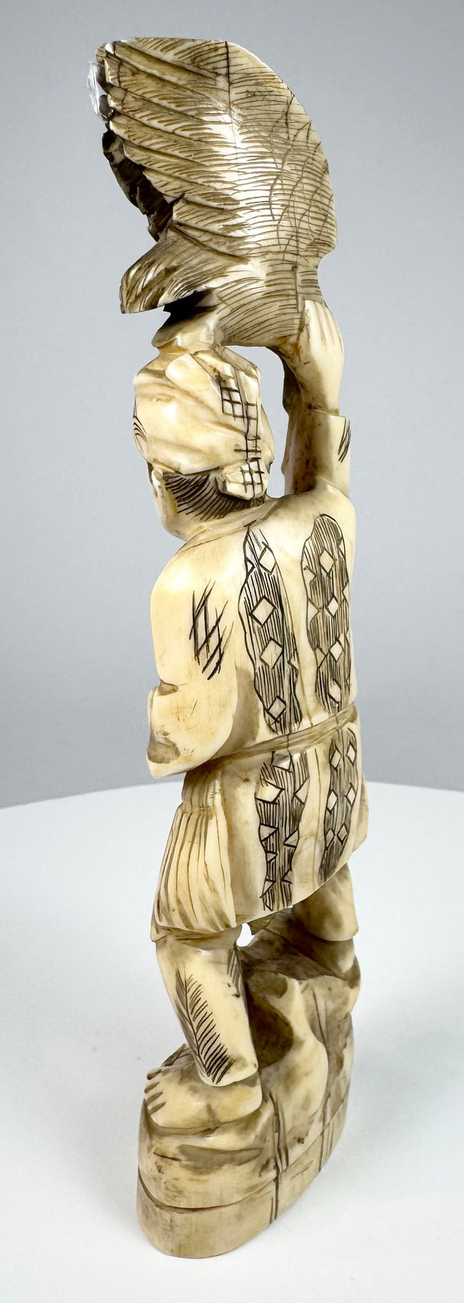 Detailed view of the carved eagle or hawk with deeply incised wing feathers