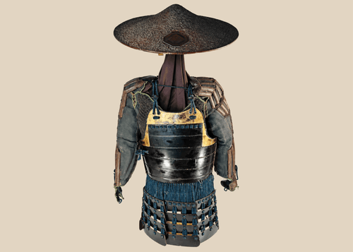 Authentic Japanese samurai armor from the Muromachi Period (1333–1573), featuring black-lacquered cuirass with gold accents, kote sleeves with chainmail reinforcement, dark-blue silk lacing, and a lacquered jingasa war hat bearing the Takeda clan crest, displayed on a wooden stand.