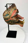 19th-century Indonesian Cakil theatrical mask shown from an angled perspective on a museum-style stand.