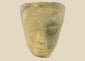 Khmer sandstone head fragment from the Angkor Period, 12th century Cambodia, depicting a serene deity or Buddha with downcast eyes and soft expression, mounted on a wooden display base, photographed on a white background.