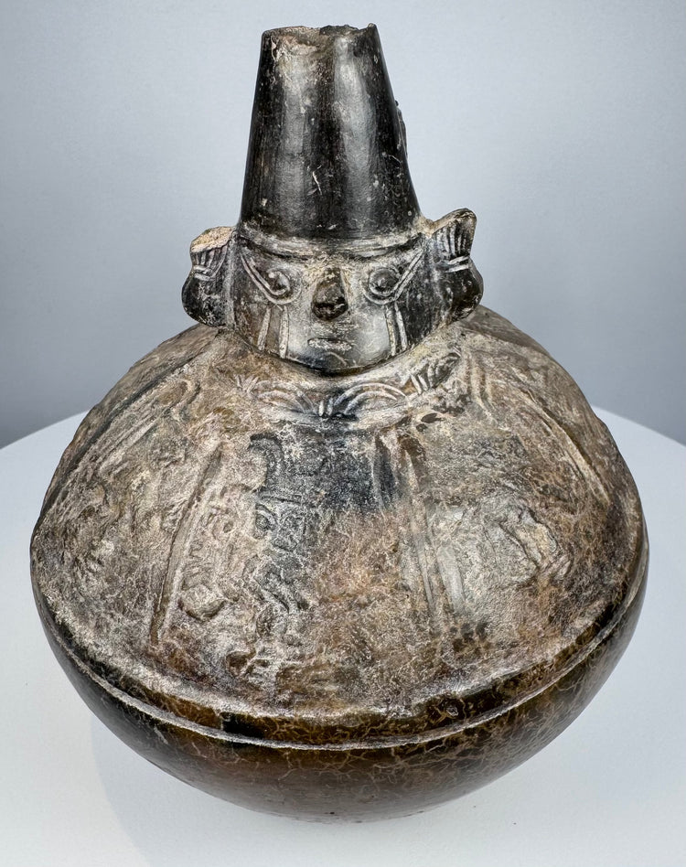 Pre-Columbian Naymlap-style bottle from northern Peru with dark burnished finish and traditional Sicán form.