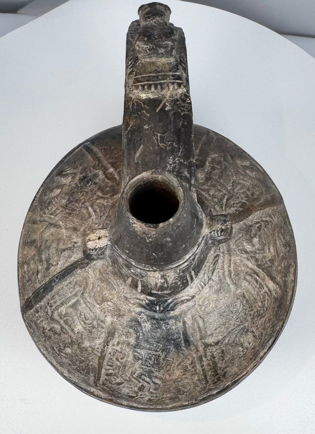 Pre-Columbian Peruvian blackware bottle associated with the Sicán culture of the Lambayeque Valley.