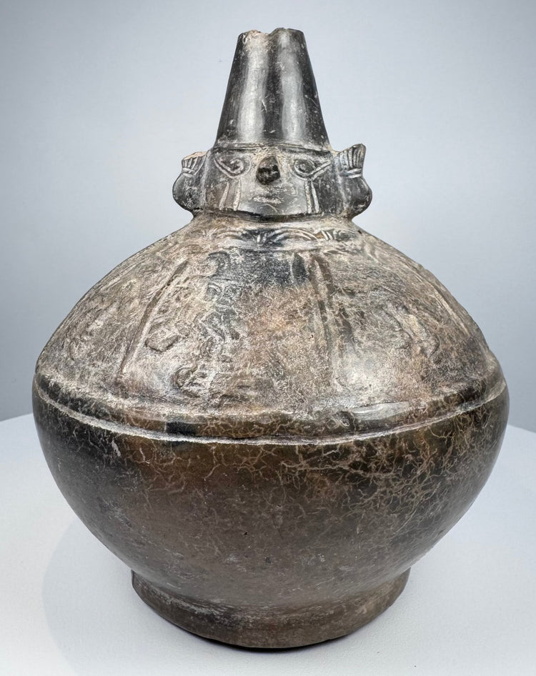Sicán culture blackware pottery vessel displaying the refined firing and burnishing techniques of ancient Peru.