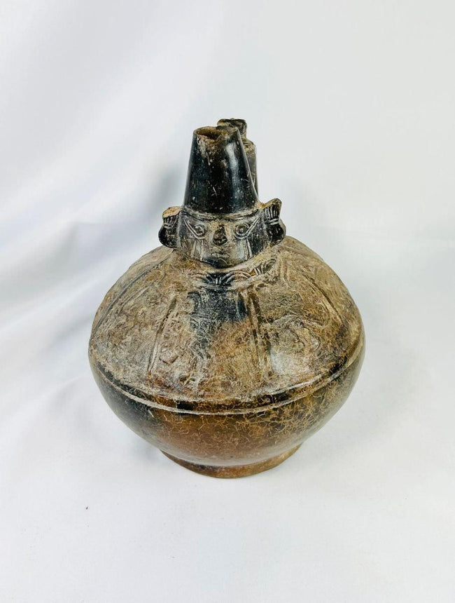 Pre-Columbian Sicán blackware ceramic vessel, upright view showing glossy surface and decorative firing patterns.