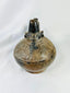 Pre-Columbian Sicán blackware ceramic vessel, upright view showing glossy surface and decorative firing patterns.