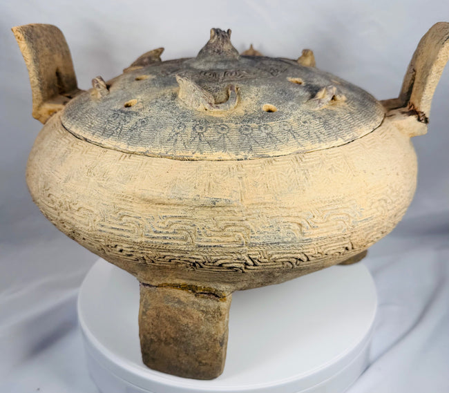 Rear view of a large terracotta ritual vessel from ancient China showcasing its upright handles and sculptural form.