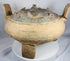 Rear view of a large terracotta ritual vessel from ancient China showcasing its upright handles and sculptural form.