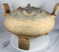 Rear view of a large terracotta ritual vessel from ancient China showcasing its upright handles and sculptural form.