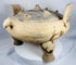 Ancient Chinese zoomorphic incense burner with three substantial tripod feet and decorative geometric ornamentation.
