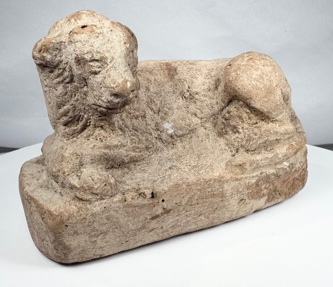 Excavated ancient Egyptian terracotta lion figure with stylized mane and weathered surface