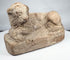 Excavated ancient Egyptian terracotta lion figure with stylized mane and weathered surface