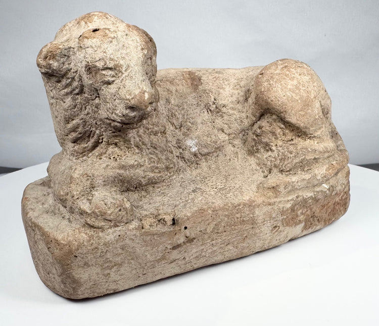 Excavated ancient Egyptian terracotta lion figure with stylized mane and weathered surface