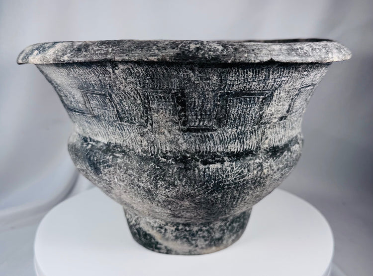 Ban Chiang-style ceramic pot with broad rim, crosshatched texture, and aged surface treatment