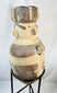 Side view of large Chancay terracotta effigy urn from ancient Peru (1000–1400 CE), Pre-Columbian ceramic vessel with human form, geometric painted bands, and ceremonial headdress, displayed on stand at Relic and Rarity.