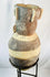 Ancient Peruvian effigy urn featuring detailed headdress and geometric decoration